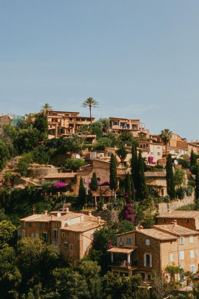 Honey-coloured houses of Deià on a green hillside