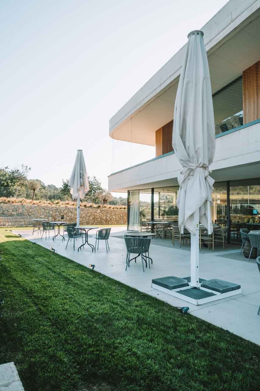 The garden terrace with lawn and parasols
