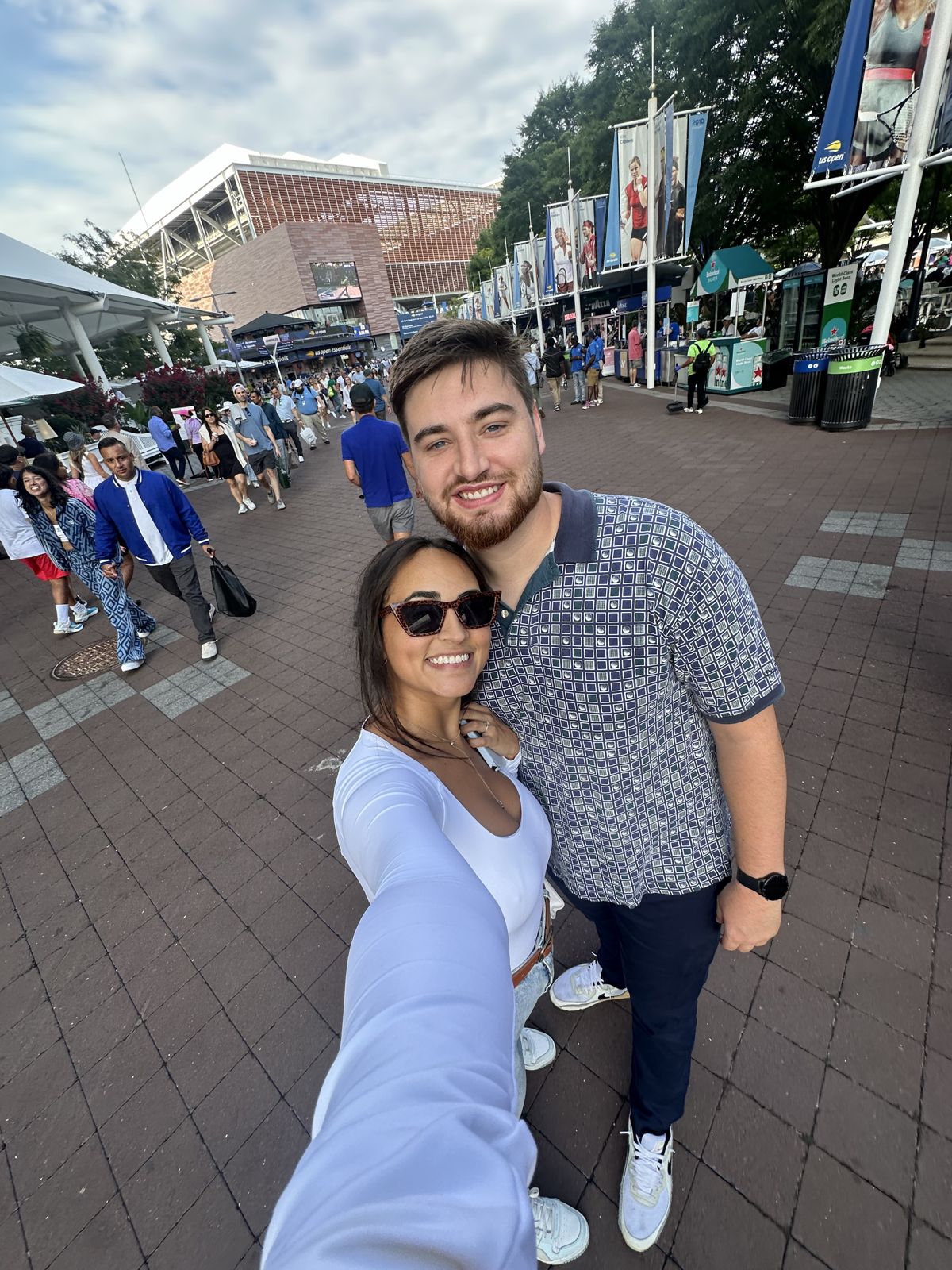 A selfie of the couple outside a tennis stadium