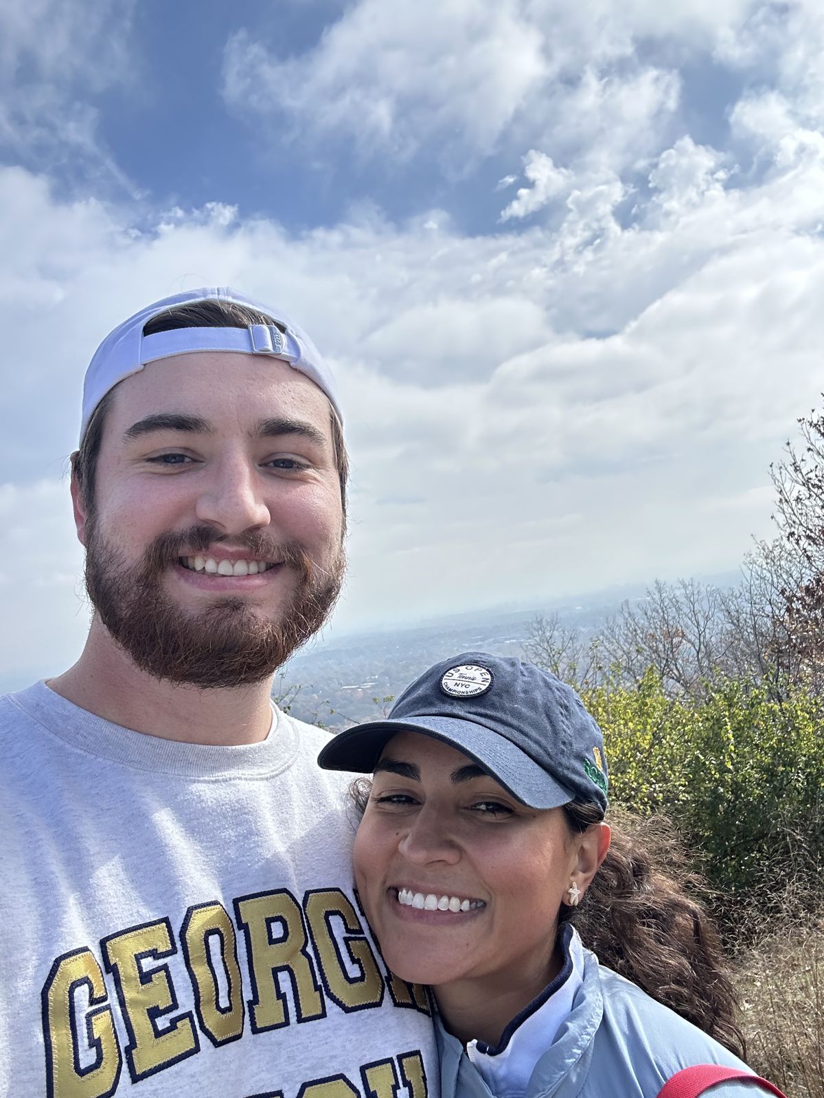 A selfie of the couple on a mountain trail