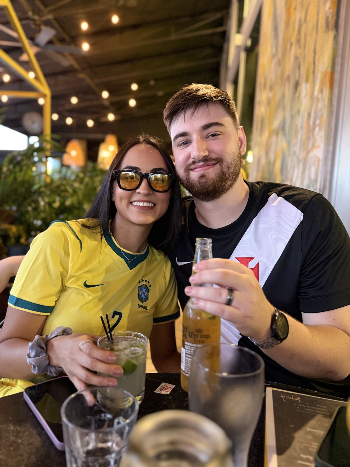 The couple at a bar, Jessica in a Brazil jersey