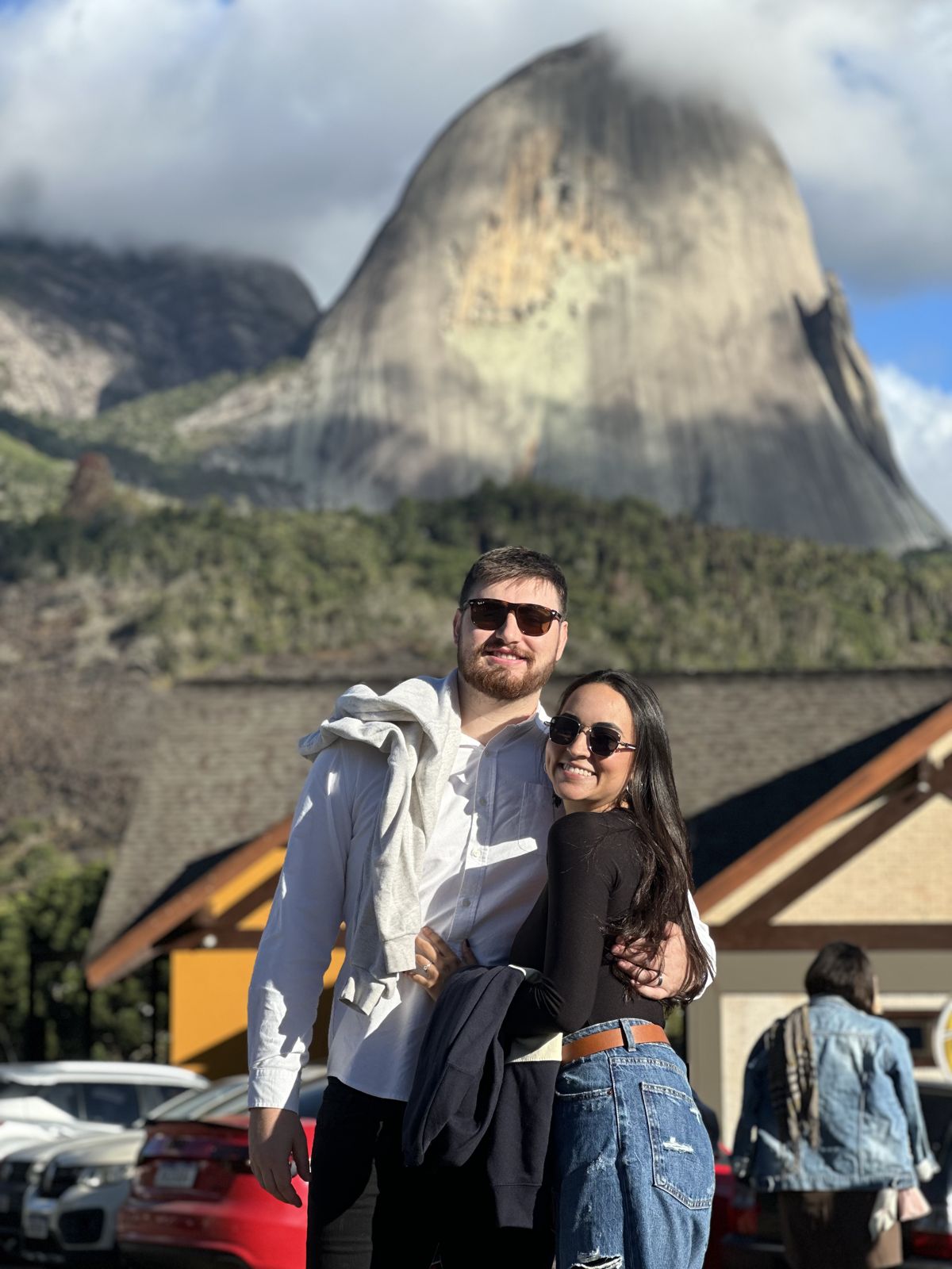 The couple in front of a huge granite peak