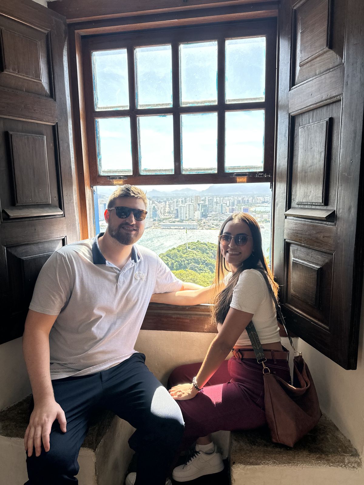The couple sitting by an old wooden window