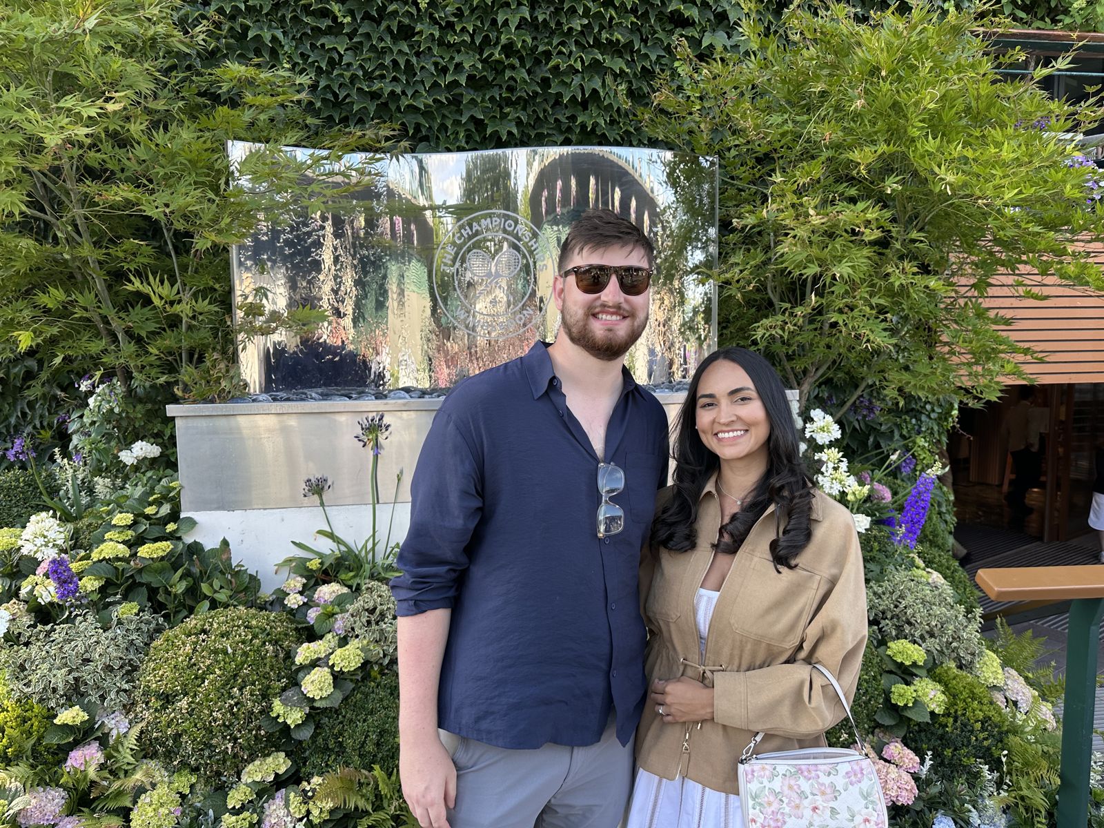 The couple among white flowers and greenery