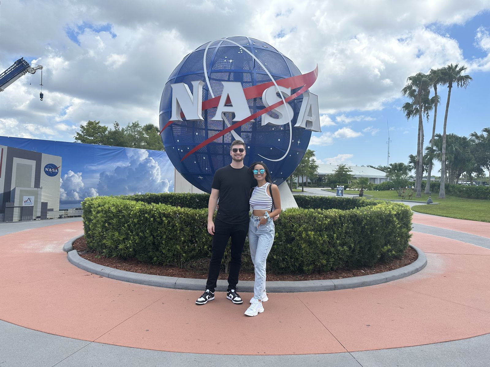 The couple in front of the NASA globe