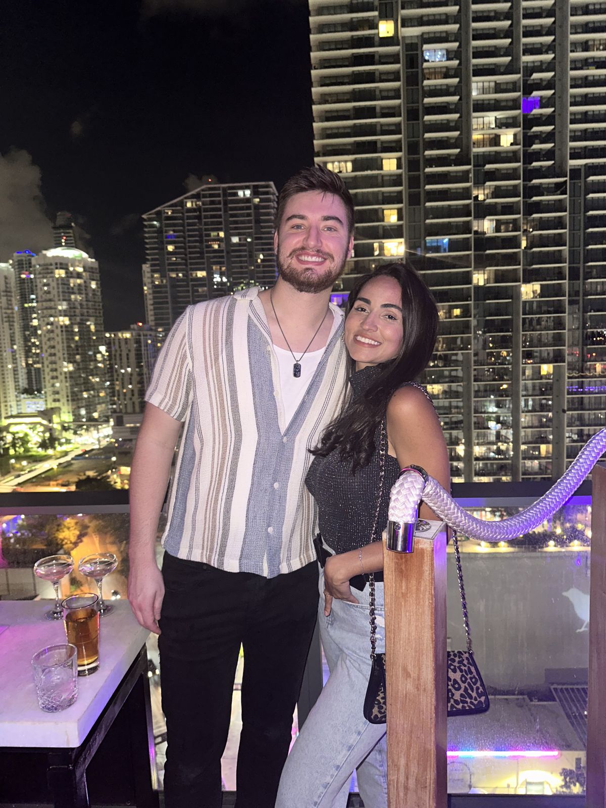 The couple on a rooftop terrace at night
