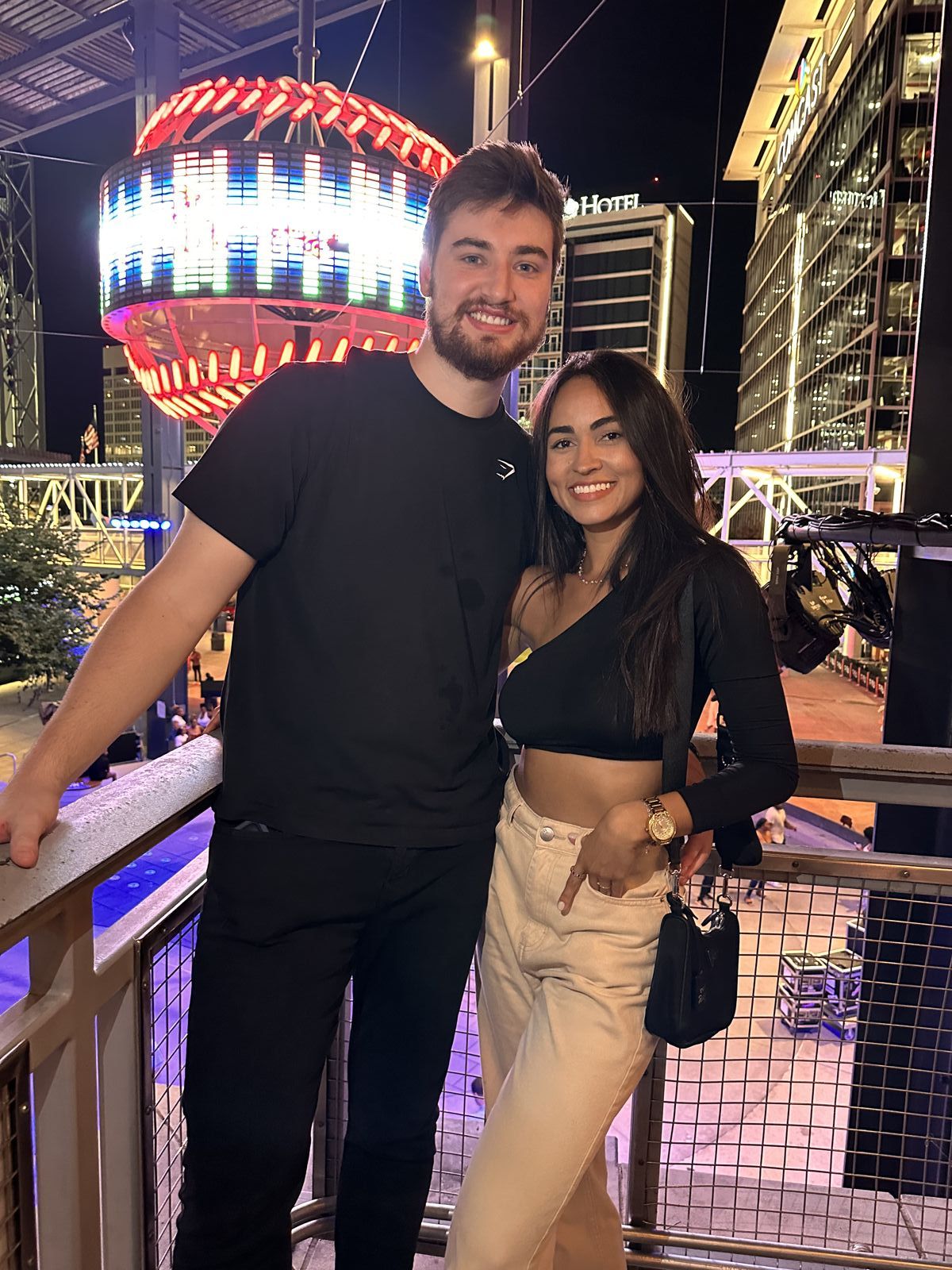 The couple under bright lights at night