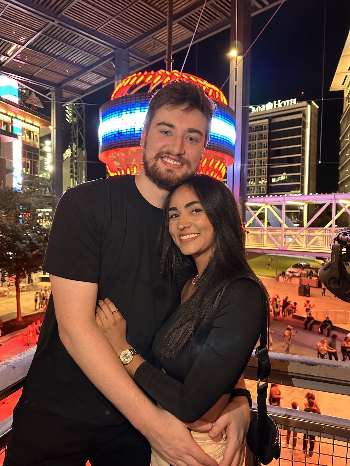 The couple hugging and smiling at night
