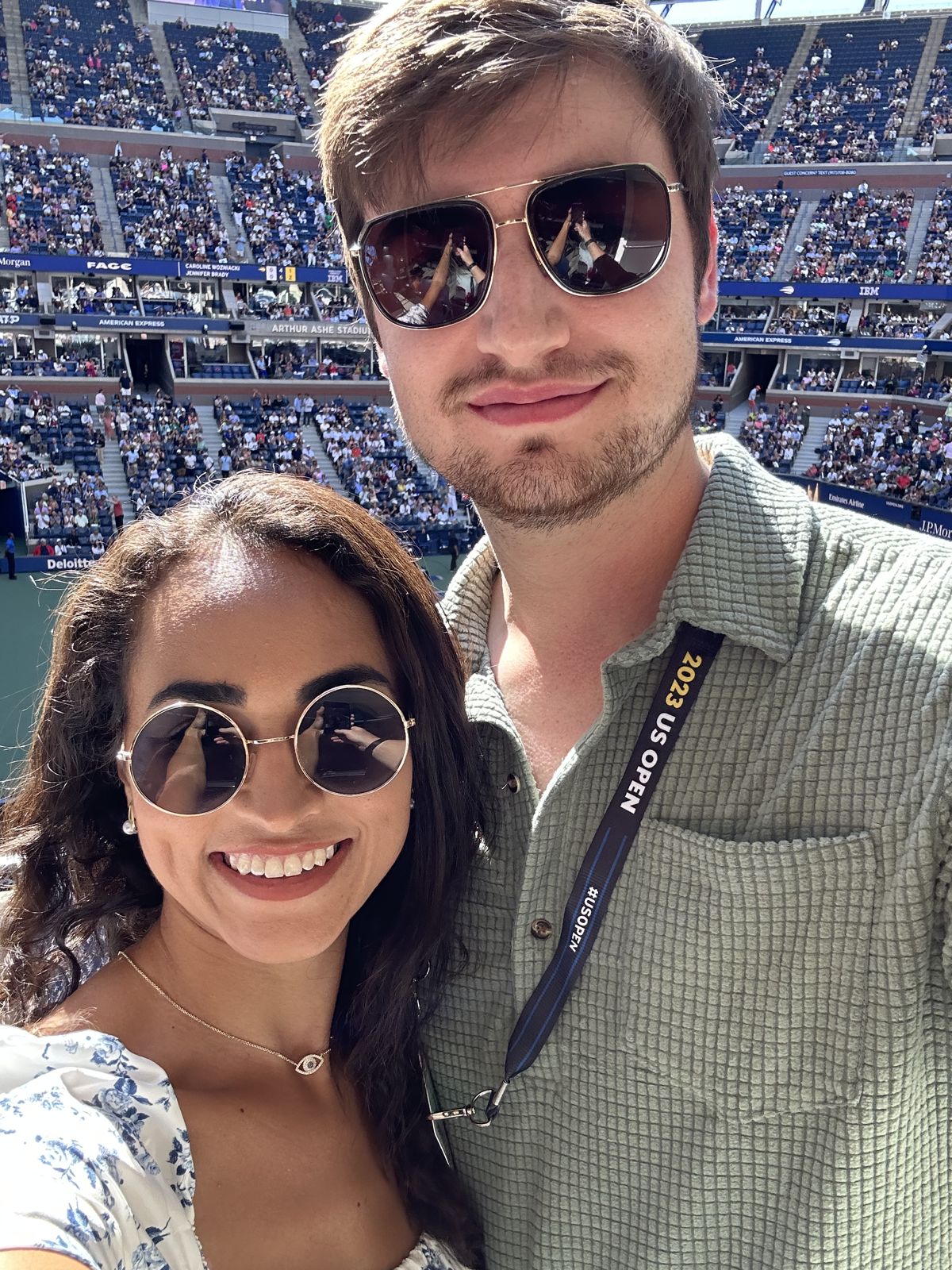 A selfie of the couple at a tennis stadium