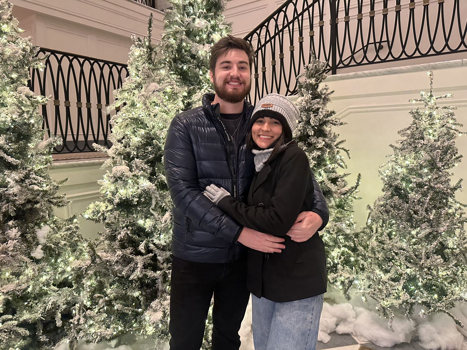 The couple among snowy Christmas trees