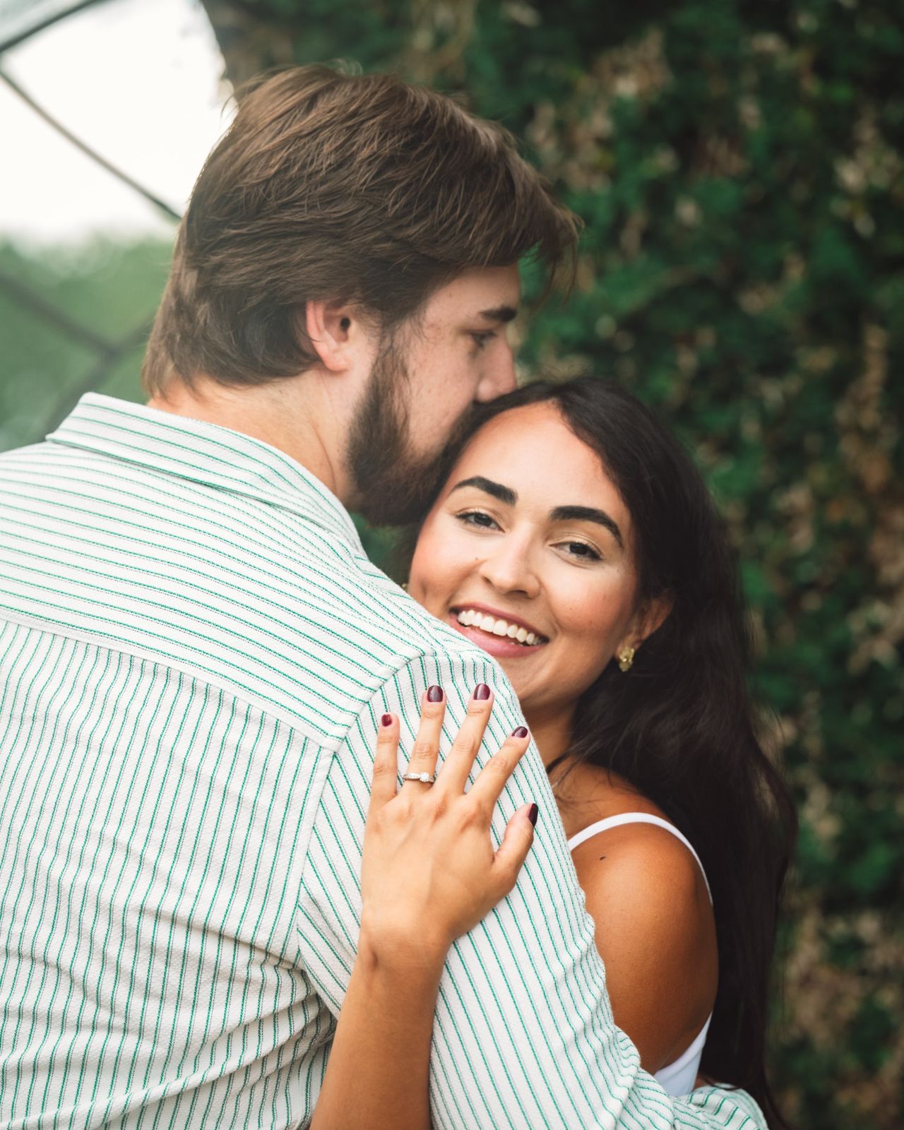 Patrick kissing Jessica’s head as she smiles at the camera